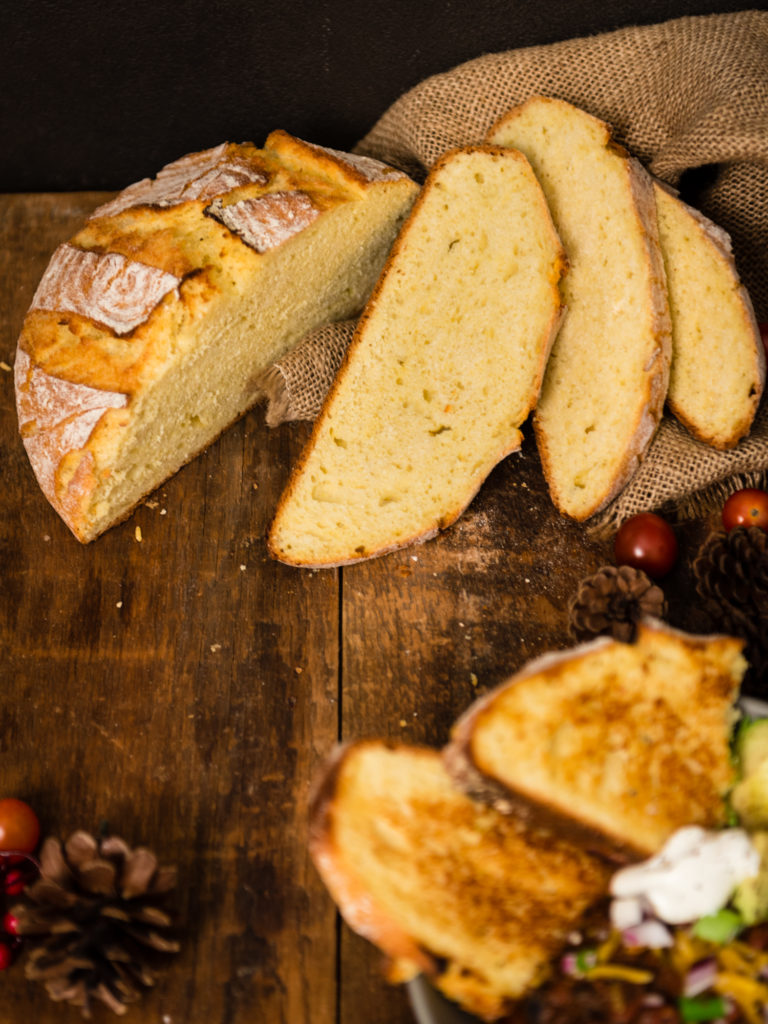 Loaf of Corn Bread sliced, chili out of focus to side | RealLifeWithDad.com