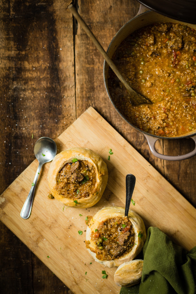 Looking down on bread bowls and dutch oven of Beef Bulgar Stew | RealLifeWithDad.com
