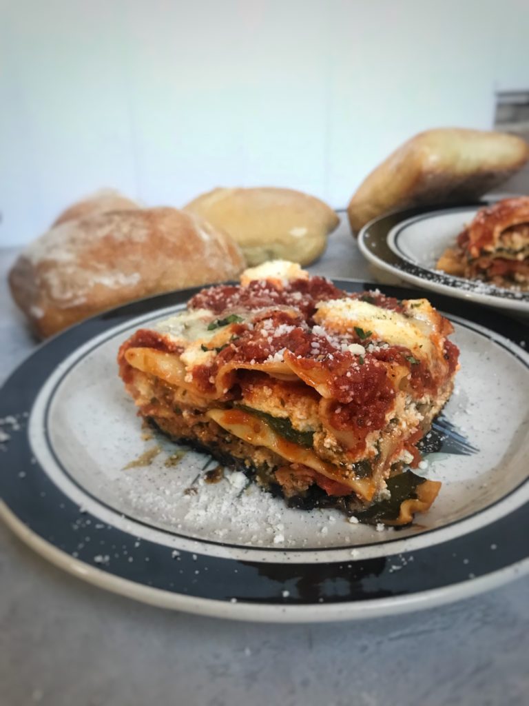 Skillet Lasagna on a plate, bread in background | RealLifeWithDad.com