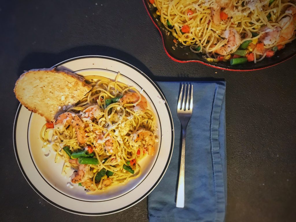 Weeknight scampi served with bread next to skillet