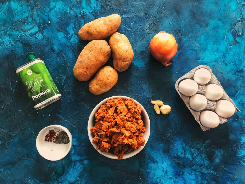 Chorizo skillet hash ingredients on a blue background